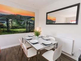 A dining room with a table and chairs at Corvesgate Nottington near Weymouth