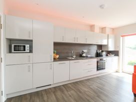 A kitchen with cabinets and appliances at Corvesgate in Nottington near Weymouth