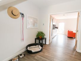 A hallway with a plant and a pet bed at Corvesgate Nottington near Weymouth