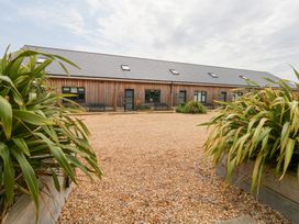 An outdoor property with a gravel area and wooden building at Corvesgate Nottington near Weymouth