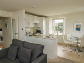 A kitchen with a sofa and dining area at Bay View in Brixham