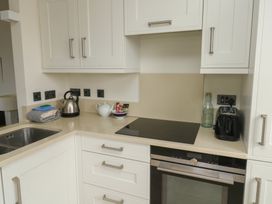 A kitchen with a kettle, toaster, and sink at Bay View in Brixham