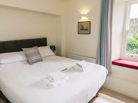 A bedroom with a bed and window at Bay View in Brixham