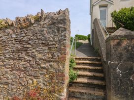 A stairway leading to a building with a stone wall at Bay View in Brixham