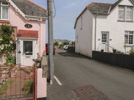 A street view of two residential houses with a gate at Bay View in Brixham