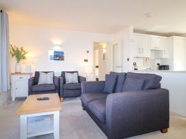A living room with furniture and a picture at Bay View in Brixham