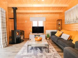 A living room with a sofa and TV at Howgills Retreat Gatebeck near Kirkby Lonsdale