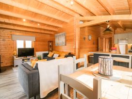 A living room with a sofa and a TV at Howgills Retreat Gatebeck near Kirkby Lonsdale