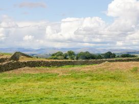 A landscape with stone wall and grass at Howgills Retreat Gatebeck near Kirkby Lonsdale