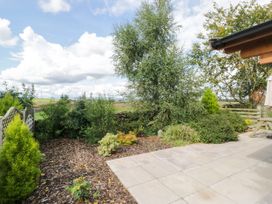 A garden with a patio and various plants at Howgills Retreat Gatebeck near Kirkby Lonsdale