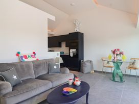 A living room with a sofa and a kitchen area at Ninky Nonk in Bristol
