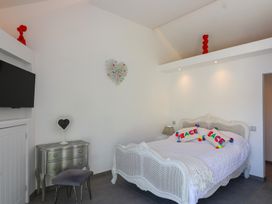 A bedroom with a bed and nightstand at Ninky Nonk in Bristol
