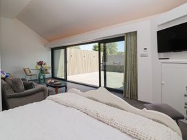 A bedroom with a bed, sofa and access to outdoor area at Ninky Nonk in Bristol