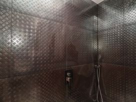 A shower with tiles and fixtures at Ninky Nonk in Bristol