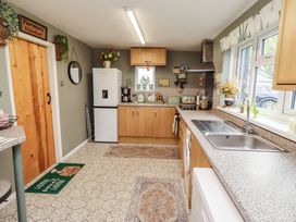 A kitchen with refrigerator and sink at Country Retreat in Ponteland