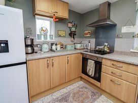 A kitchen with appliances and cabinet at Country Retreat Ponteland