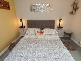 A bedroom with a bed and a nightstand at Country Retreat in Ponteland
