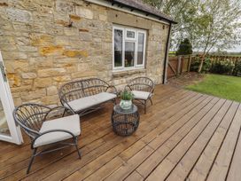 An outdoor seating area with chairs and a coffee table at Country Retreat in Ponteland