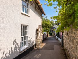 A pathway alongside a building with a gate at The Nest in Lyme Regis