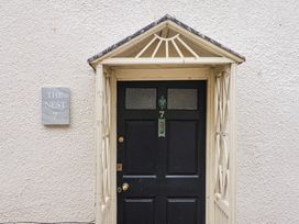 An entrance with a door and nameplate at The Nest in Lyme Regis