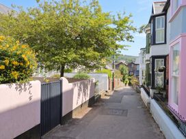 A walkway lined with houses and plants at The Nest in Lyme Regis