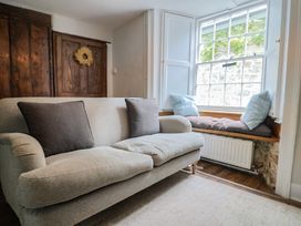 A living room with a sofa and window seat at The Nest in Lyme Regis