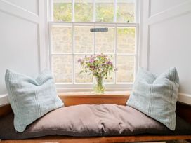 A snug area with pillows and a flower vase at The Nest in Lyme Regis