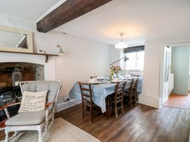 A dining room with a table and chairs at The Nest in Lyme Regis