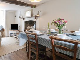 A dining room with a table set for a meal at The Nest in Lyme Regis