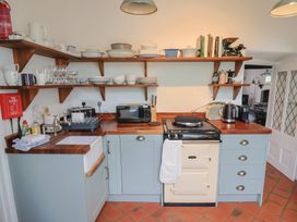 A kitchen with shelves and appliances at The Nest in Lyme Regis