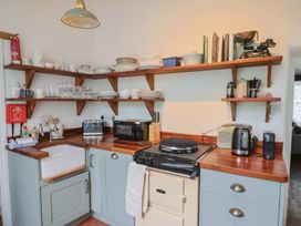 A kitchen with shelves and dishes organized at The Nest in Lyme Regis