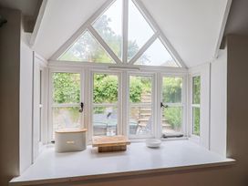 A kitchen window with a cutting board and bowl at The Nest in Lyme Regis