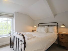 A bedroom with a bed and bedside tables at The Nest in Lyme Regis