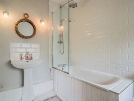 A bathroom with a sink and bathtub at The Nest in Lyme Regis