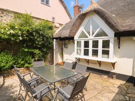 An outdoor area with a table and chairs at The Nest in Lyme Regis