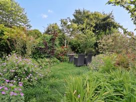 A garden with seating area and flowers at The Nest in Lyme Regis