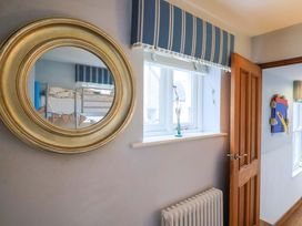 A mirror and radiator in a bedroom at Seaside Lyme Regis