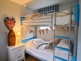A bedroom with bunk bed and single bed at Seaside in Lyme Regis