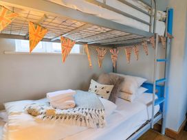 A bunk bed with pillows and throws at Seaside in Lyme Regis