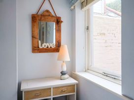 A table with a lamp and mirror in a room at Seaside in Lyme Regis