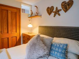 A bedroom with a bed and decorative art at Seaside in Lyme Regis