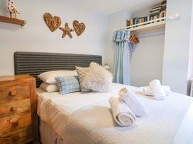 A bedroom with a bed and decorative items at Seaside in Lyme Regis