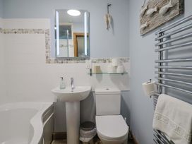 A bathroom with a sink, toilet, and bathtub at Seaside in Lyme Regis
