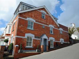 A brick building with windows and landscaping at Seaside in Lyme Regis