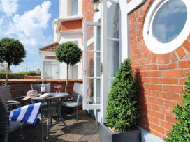 An outdoor area with a table and chairs at Seaside in Lyme Regis