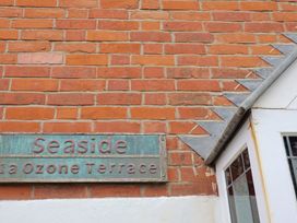 A wall with a house sign at Seaside in Lyme Regis
