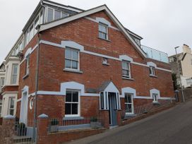 A building with brick walls and multiple windows at Seaside in Lyme Regis