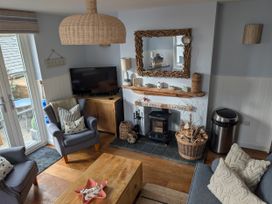 A living room with a fireplace and television at Seaside in Lyme Regis