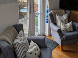 A living room with two chairs and a table at Seaside in Lyme Regis