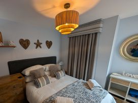 A bedroom with a bed and decorative items at Seaside in Lyme Regis